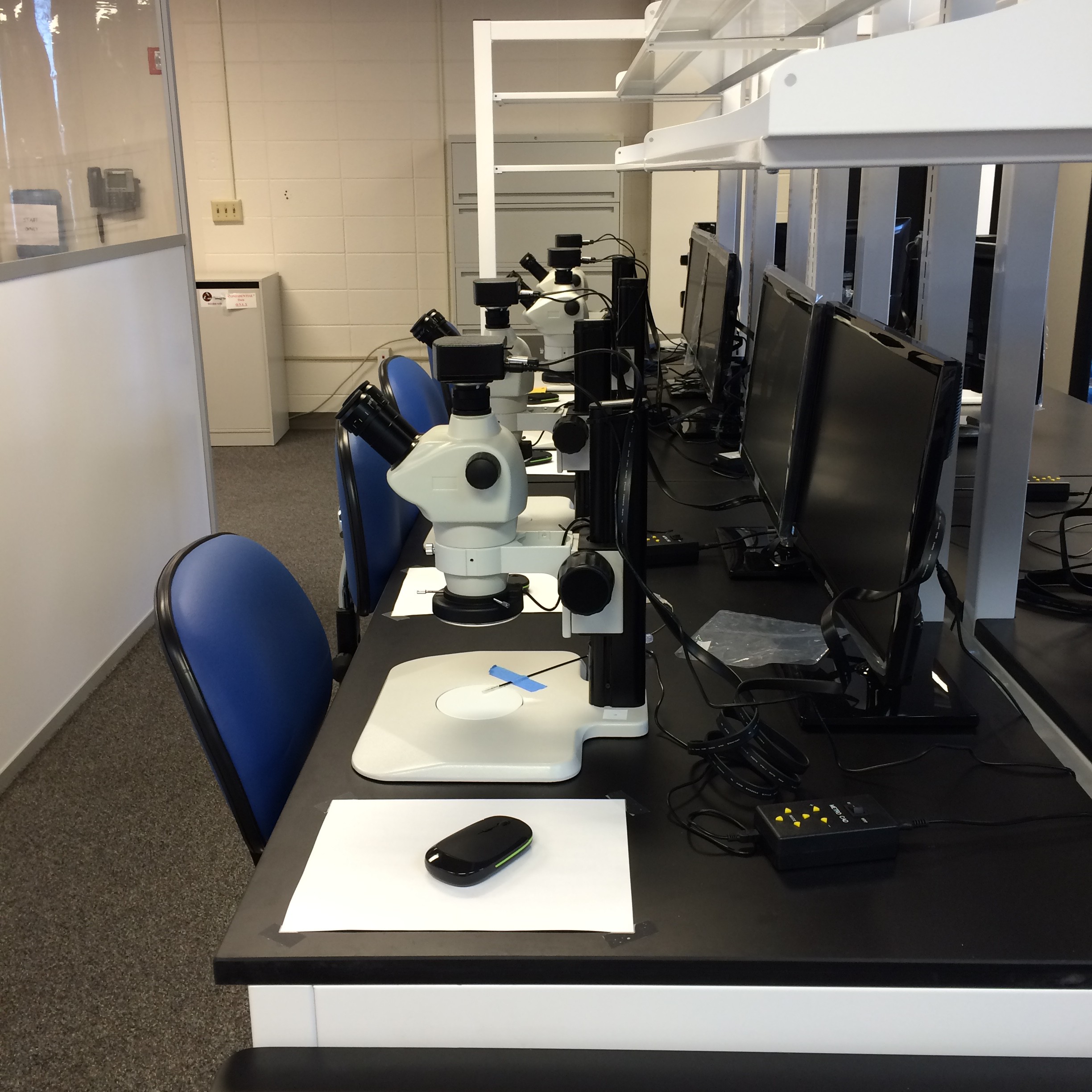 Row of microscopes attached to computers