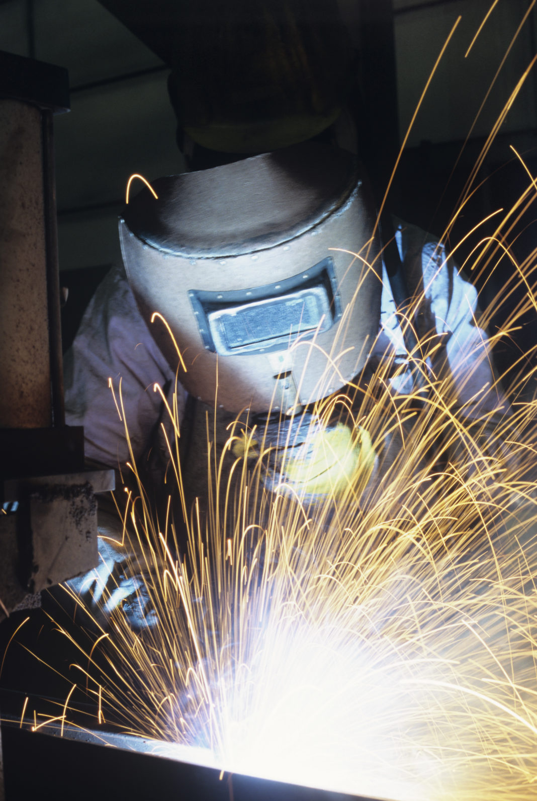 Welder in welding helmet
